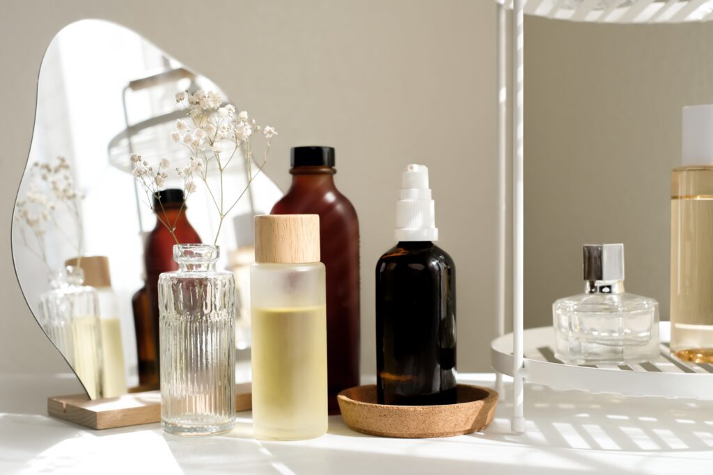 Assorted skincare and cosmetic product bottles on vanity, illustrating wellness branding and beauty product marketing visuals.
