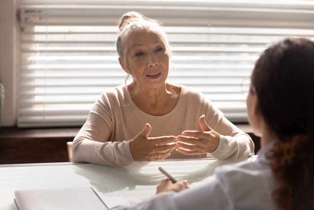 Senior patient giving testimonial during consultation with physician, emphasizing patient satisfaction, trust, and credibility in healthcare content marketing.