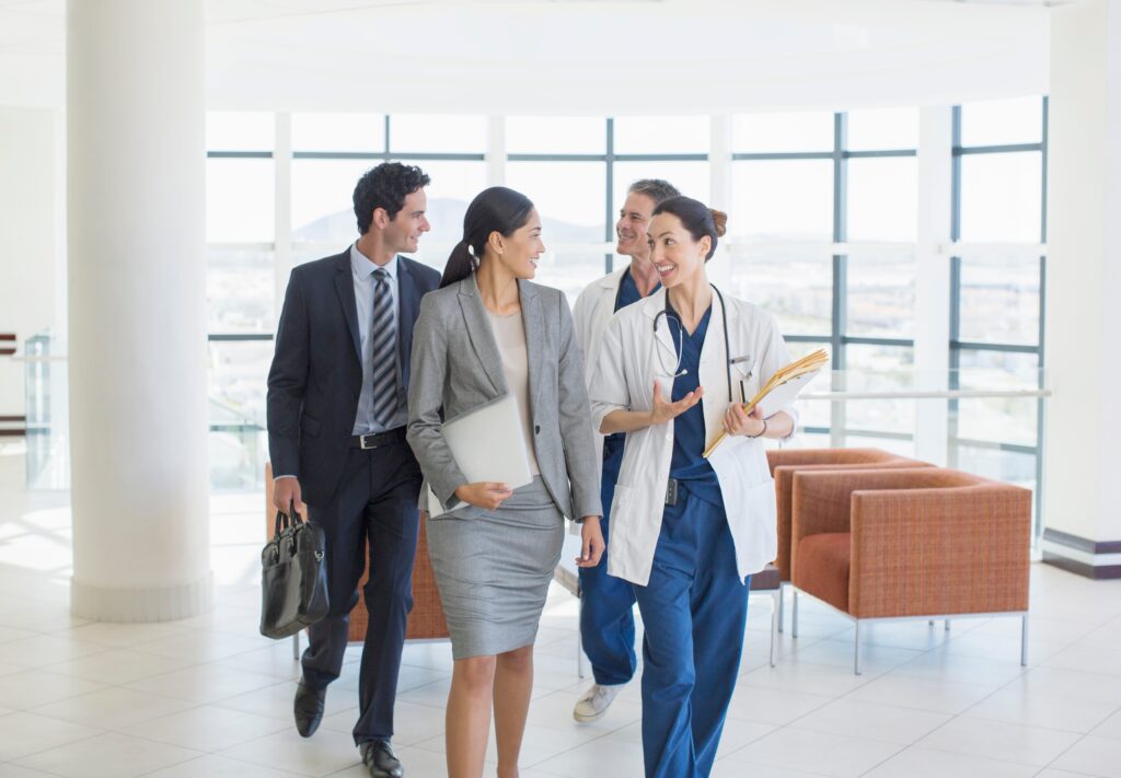 Medical staff and business professionals collaborating in a healthcare facility, illustrating healthcare marketing strategy, campaign management, and digital advertising alignment with organizational goals.