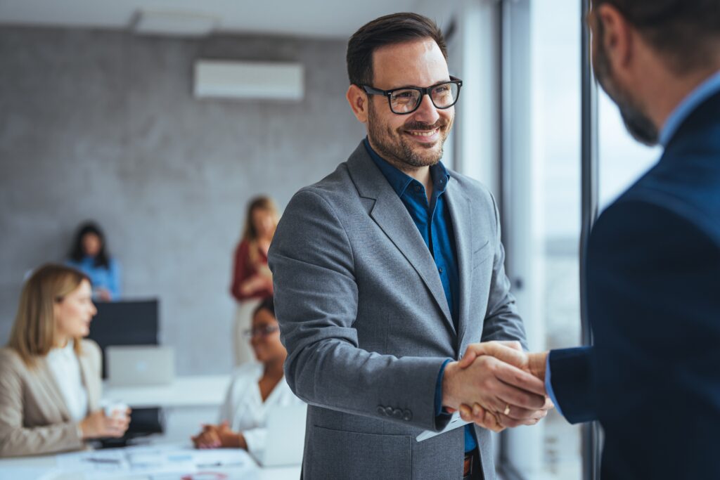 Professional services business handshake symbolizing trust and lead generation in B2B email marketing for law firms, accountants, and financial advisors.