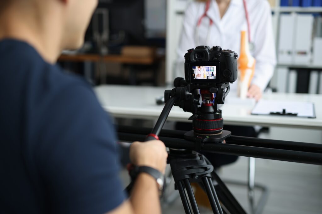 Videographer recording healthcare professional testimonial for digital marketing campaign, showcasing patient experience and brand trust in medical marketing.