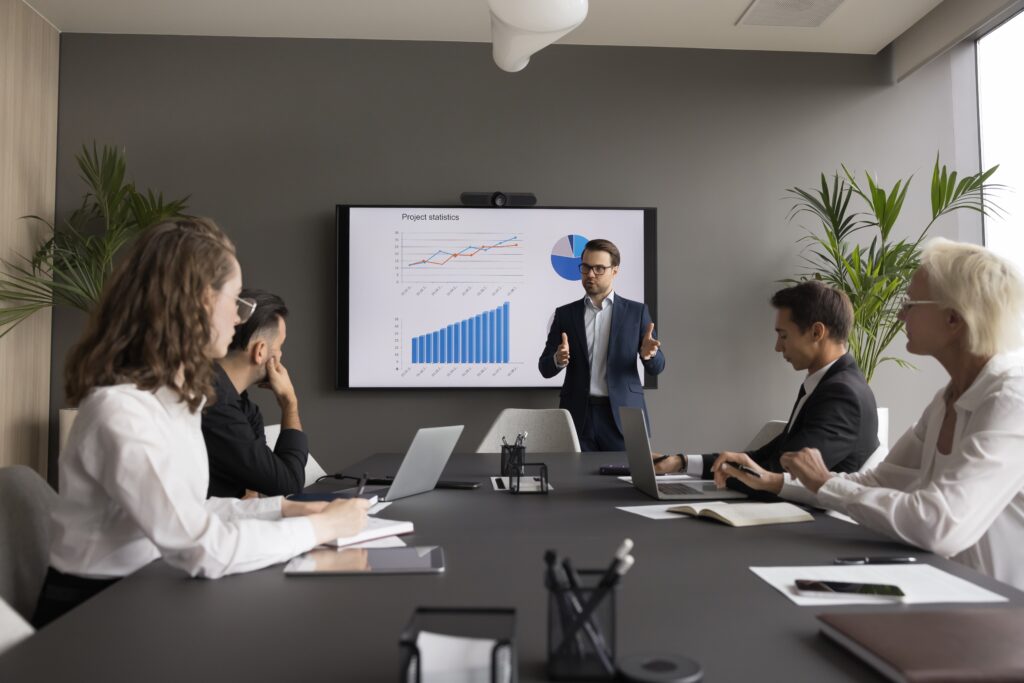 Financial advisor presenting brand equity, ROI, and marketing strategy data in a professional services team meeting.