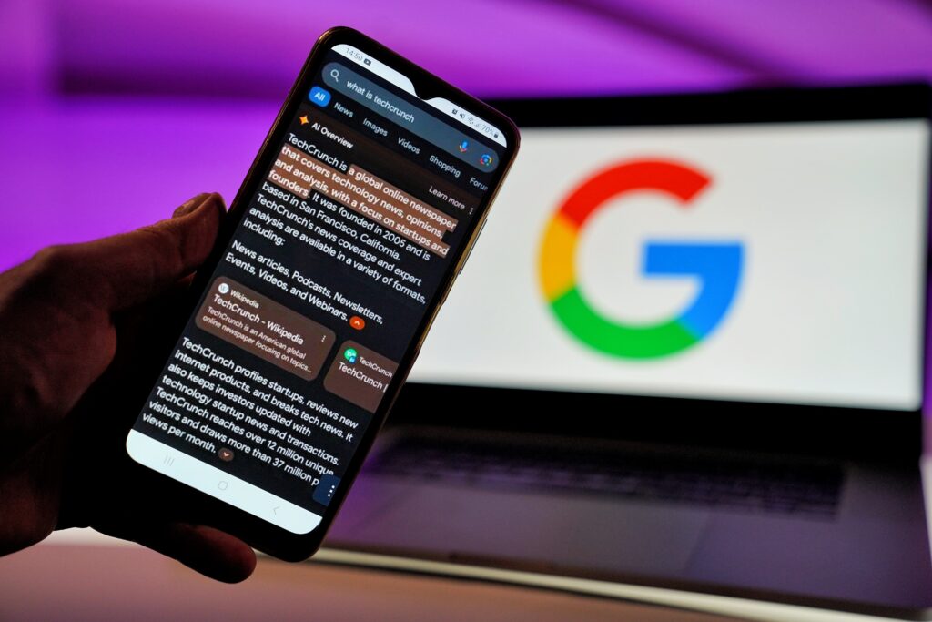 Close-up of user interacting with AI-powered search on smartphone, symbolizing machine learning, user behavior analysis, and automation in search advertising, relevant to Google AI Max, search queries, and PPC marketing strategies.