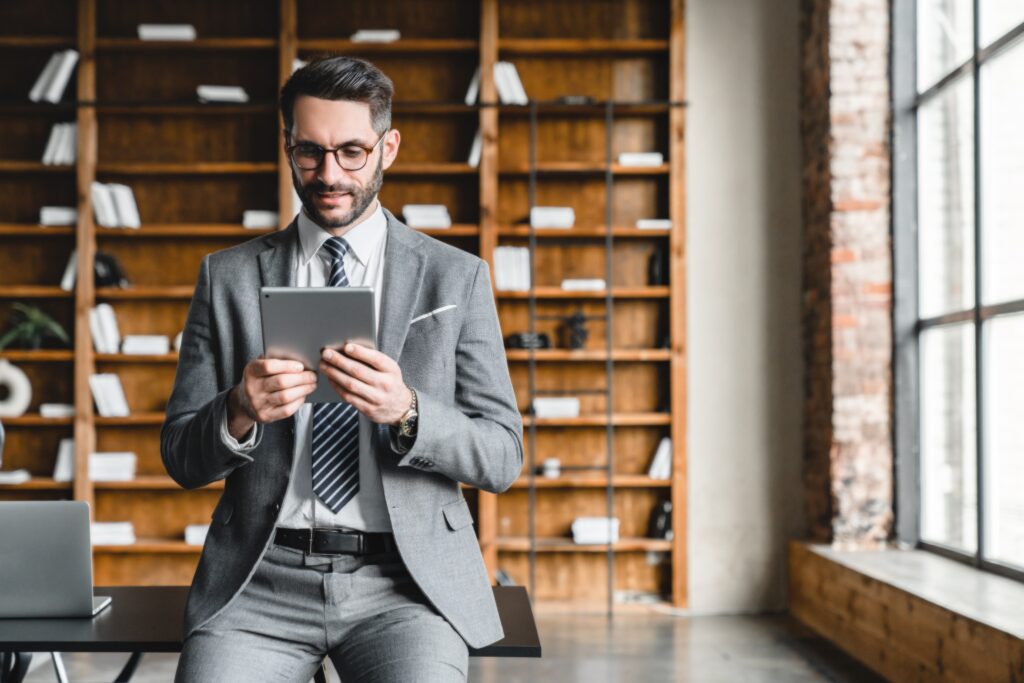 Attorney using a tablet for legal research and blog publishing, illustrating content creation, legal tech integration, and SEO-focused digital marketing for law firms.