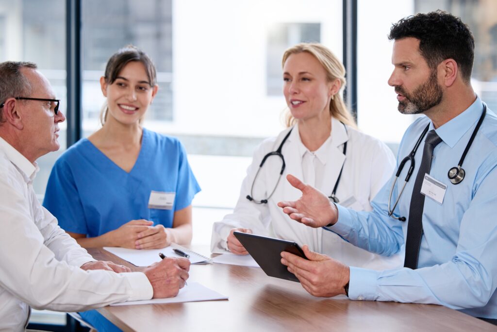 Healthcare professionals and nurses conducting a patient consultation—illustrating interdisciplinary care, electronic health record integration, and CRM-driven patient management in clinical settings.