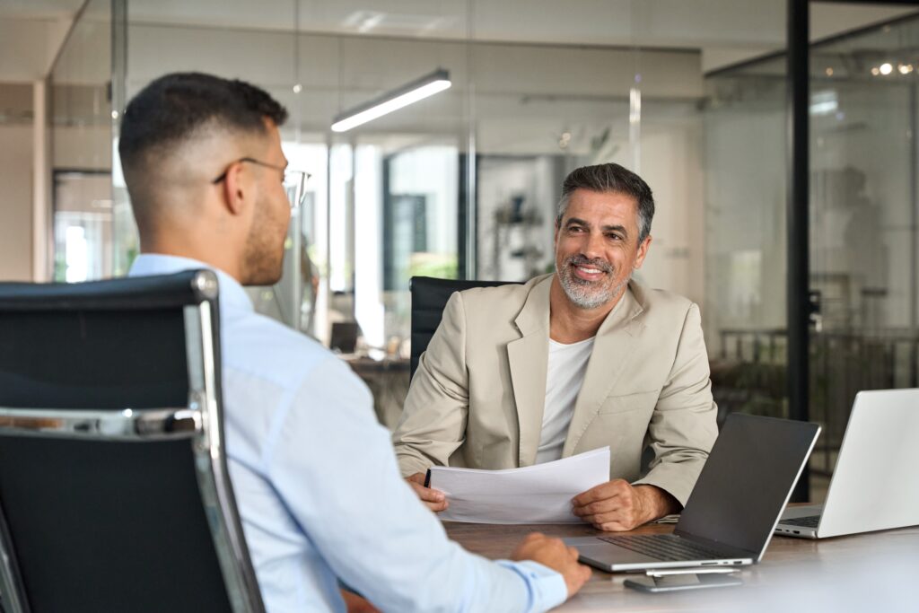 B2B marketing professionals in a modern office discussing ecommerce checkout optimization, CRM integration, and trade credit solutions to improve customer satisfaction and sales performance.
