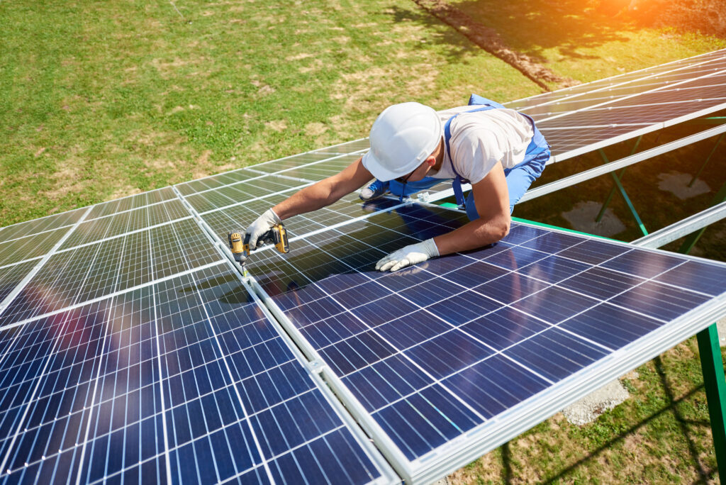 Home services technician installing solar panels to promote energy efficiency and sustainability for homeowners investing in green home improvement solutions in 2025.