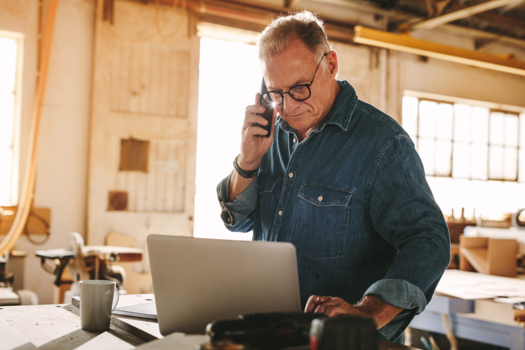 Home services business owner managing customer calls and online marketing strategies using data and software to improve local search visibility and boost revenue in 2025.
