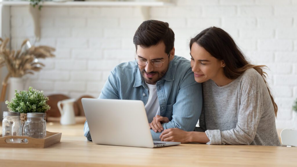 Happy couple shopping online on an ecommerce website, exploring optimized product pages for a seamless user experience and improved conversion rates.