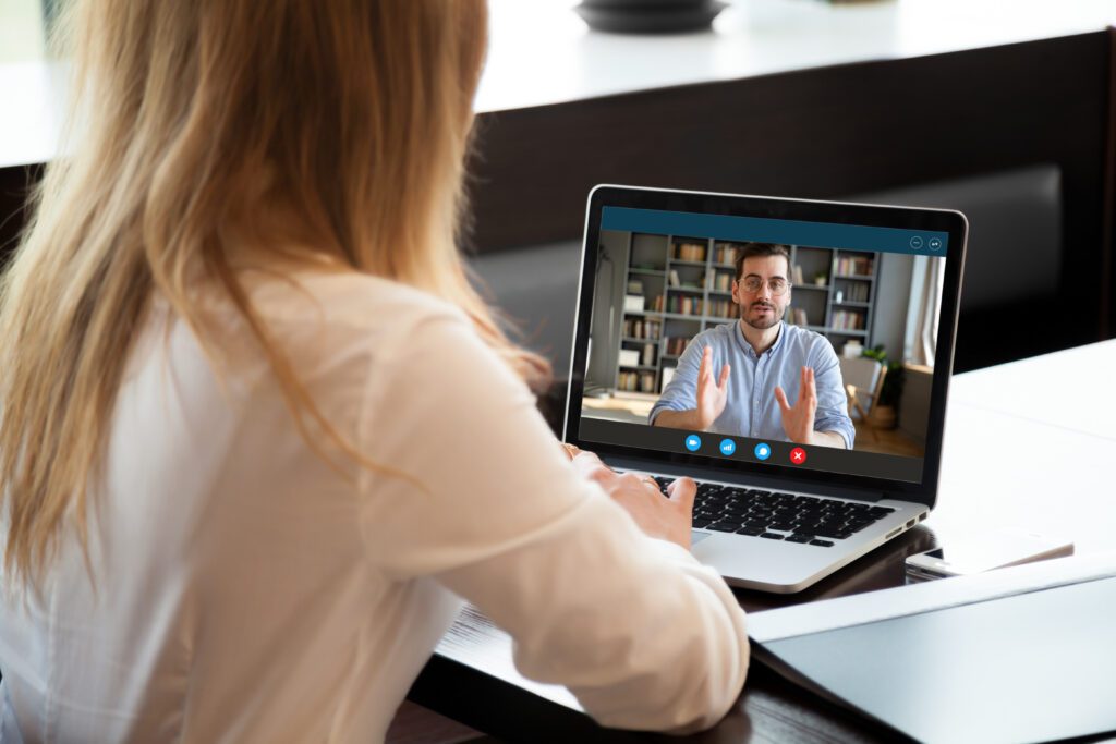 Professional woman attending a virtual web conferencing meeting for lead generation and client engagement strategy, showcasing marketing automation and digital marketing for professional services.