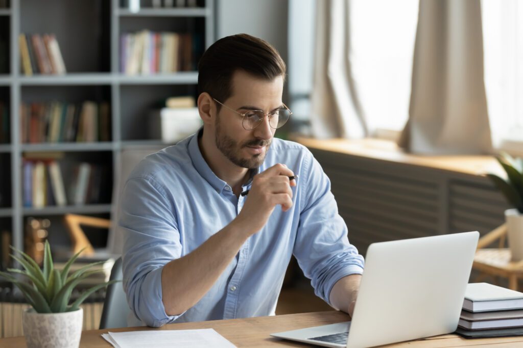 Consultant using predictive analytics and CRM software on a laptop to improve lead generation, lead scoring, and customer relationship management for professional services firms