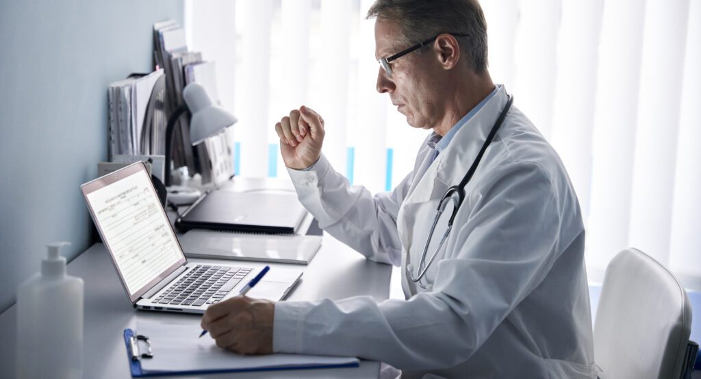 Physician analyzing patient information and website analytics to optimize SEO, manage online reputation, and improve practice visibility in local search.