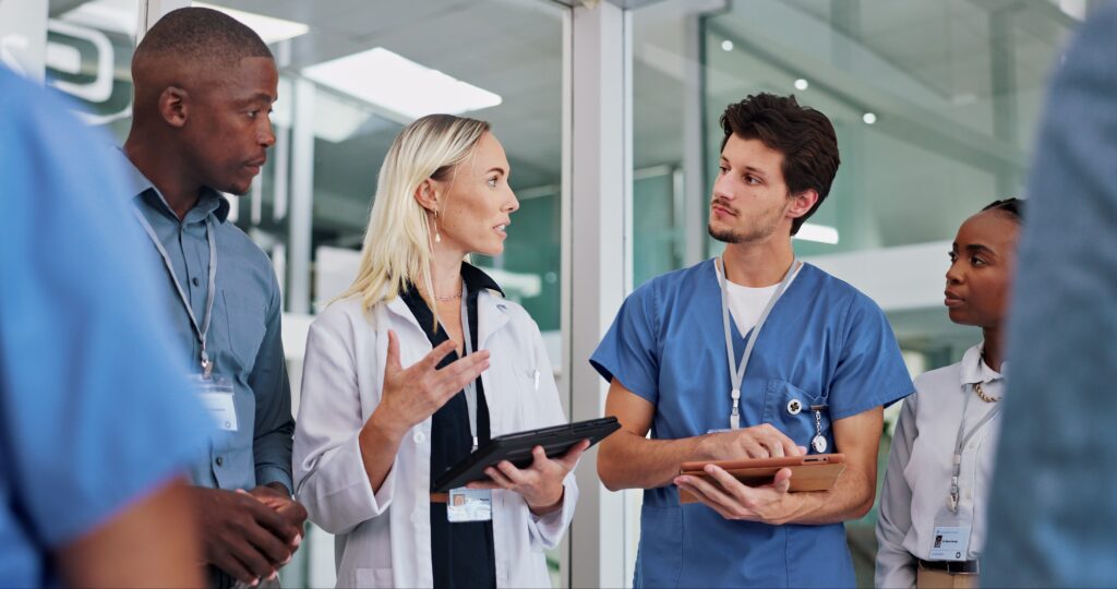 Diverse healthcare professionals collaborating on digital marketing strategies to improve local SEO for clinics, hospitals, and urgent care centers.