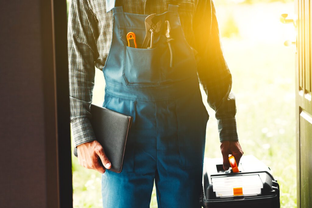 Home services technician arriving for HVAC, plumbing, or electrical repair, representing trusted brand presence and professional service quality.