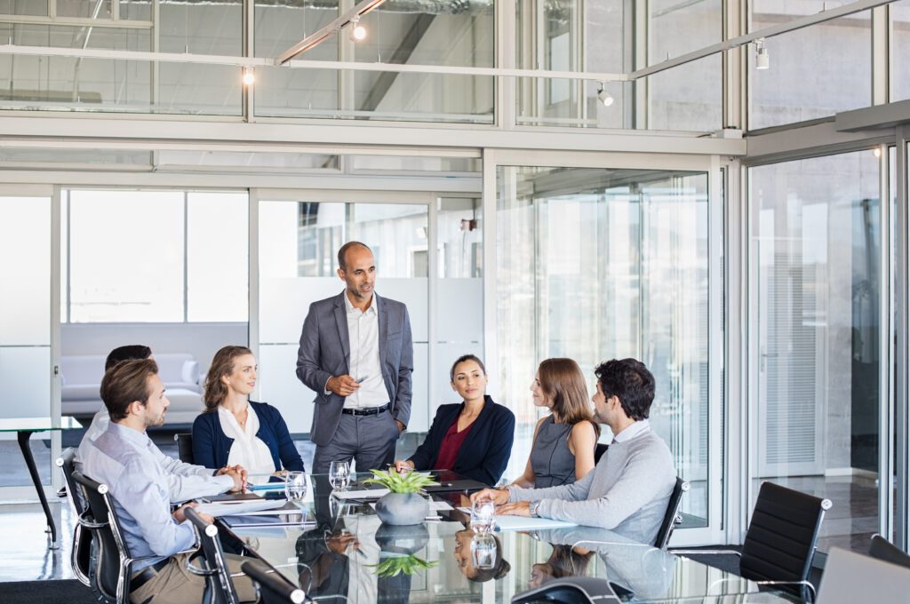Professional service firm executives strategizing digital marketing campaigns, focusing on brand development, customer experience, and marketing automation in a modern office setting.