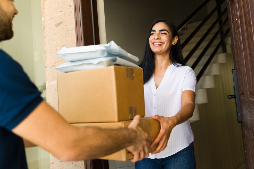 Happy customer receiving ecommerce delivery, illustrating successful conversion from personalized email marketing and improved customer experience in online shopping.