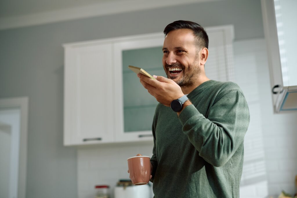 Homeowner using smartphone voice search to find local HVAC, plumbing, and electrical services optimized through digital marketing and local SEO"